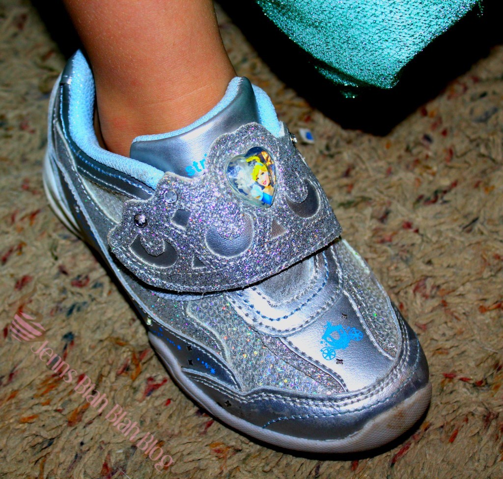 4 Tips For Purchasing Kids Shoes For Halloween toddler showing off her silver sparking shoes with lights from Disney Pincesses
