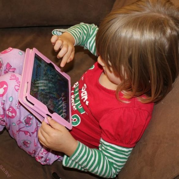 little girl playing game on ipad mini